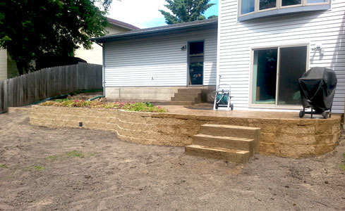 Brick Retaining Wall with Stamped Concrete Patio & Steps